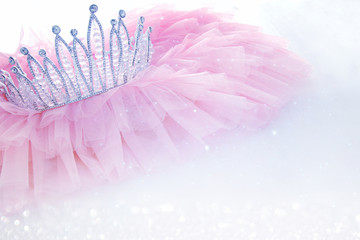 Vintage tulle pink chiffon dress and diamond tiara on wooden white table. Wedding and girl's party concept © tomertu