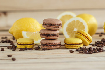 Yellow and brown french macarons with lemons and coffee beans