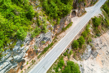 Fototapeta na wymiar Top view of an empty asphalt road and a tunnel in the mountains