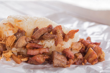 pork fried Close up with sticky rice on wrap paper fast food Thailand