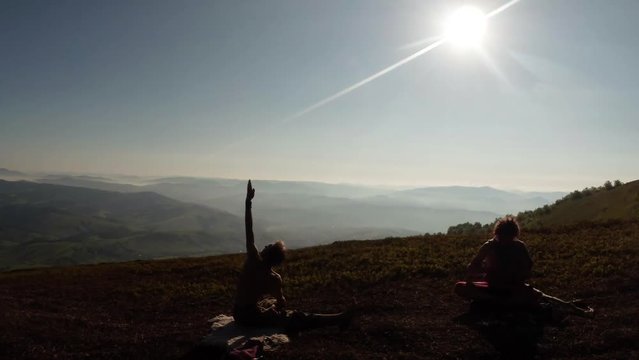 Marichi's, Marichyasana, Paryvrytta Gianni Shyrshasana Yoga in the Silhouettes in the Mountains Under the Rays of the Sun in the Early Morning