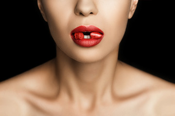 Fototapeta premium cropped view of seductive woman with red lipstick in mouth, isolated on black
