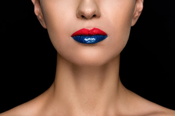 cropped view of seductive fashionable woman with blue and red lips, isolated on black