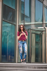 Girl with sunglasses using mobile phone