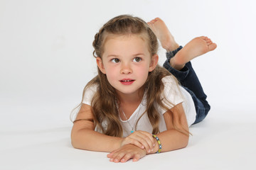 Kind liegt barfuß auf dem Boden weisser Hintergrund