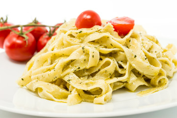 Pasta with pesto sauce and nuts on a the table