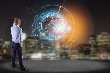 InternatiBusinessman in front of a wall with a  globe communication displayed on a futuristic interface - Business and technology connection