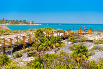 The bridge to the sandy beach Playa Paradise of the island of Cayo Largo, Cuba. Copy space for text.