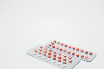 Contraceptive pills on white background
