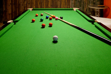 snooker balls and cue on snooker table