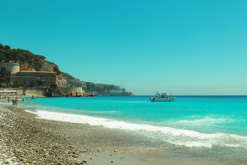 Crowded Mediterranean summer beach in City of Nice