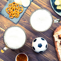 Fototapeta na wymiar Appetizers and beer on the table for watch the football match.