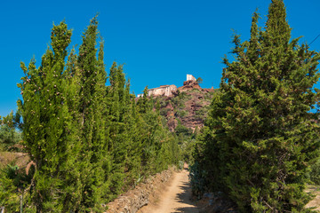 Ancient church of Mare de Deu de la Roca, near the town of Montbrio del Camp, Tarragona, Catalunya, Spain. Copy space for text. Isolated on blue background.