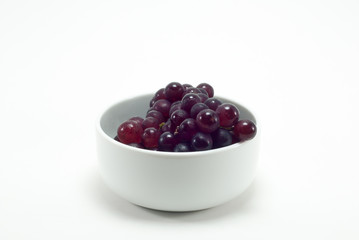 Grapes in a white cup