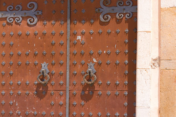 Antique wrought iron door of a church of Sant Bartomeu and Santa Tecla in Sitges,  Barcelona,...