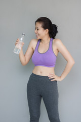 Young woman are drinking water after exercise.