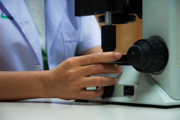 Doctor woman with microscope in laboratory room. Scientific research