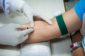 Medical technologist doing a blood draw examination in laboratory room. hospital