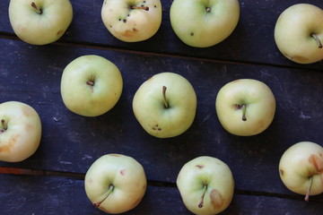 Green apples on the old vintage table