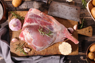 raw lamb leg on board