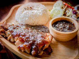 Rice, Delicious steaks with seasonings and herbs on wooden dish.