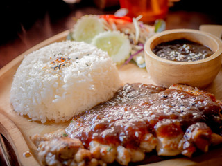 Rice, Delicious steaks with seasonings and herbs on wooden dish.