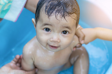 Asian baby girl bathing