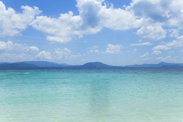 Andaman Sea, emerald water, blue sky, beautiful clouds and mountains.