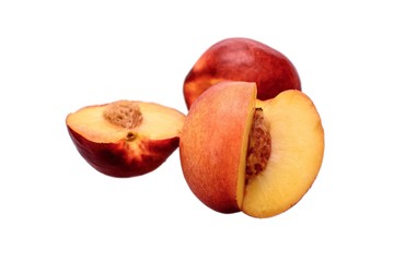 Peaches whole and sliced halves with a bone isolated on white background