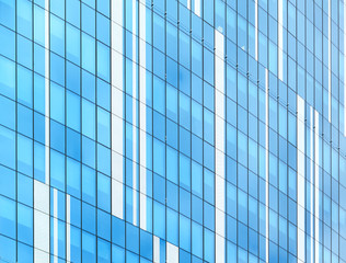 Glass facade of modern building. Cloudy sky reflects in glass