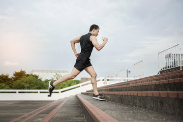 Handsome Sport man running at outdoor city