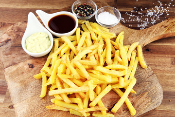 Close up Crispy Potato Fries with Two Dipping Sauce, Served on Rustic Wooden Table