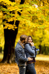 Young loving couple in the autumn park