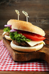 Delicious fresh homemade burger on a wooden table