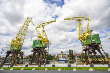 Renovated cranes on the boulevards in Szczecin on a sunny summer day - obrazy, fototapety, plakaty