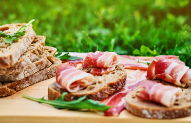 Bread with gourmet meat on a wooden desk.