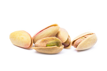 Pile of roasted pistachios isolated on white background
