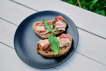 Bread with ham and herbs on a plate.