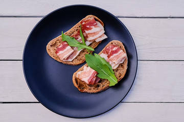 Bread with ham and herbs on a plate.