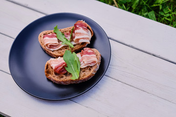 Bread with ham and herbs on a plate.