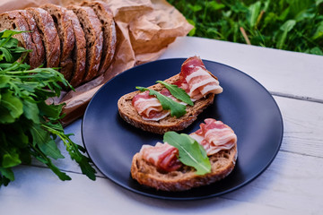 Bread with ham and herbs on a plate.