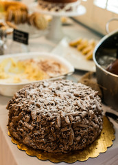 Noodle cake with white powder on table