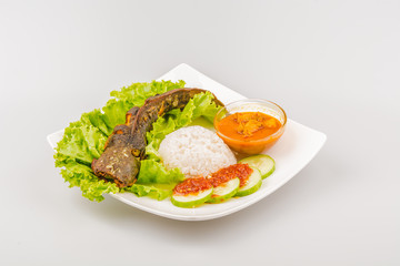 Isolated catfish fried ala Indonesia with condiments, Indonesian food