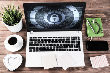 Web security and technology concept with laptop on wooden table
