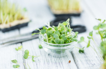 Fresh cutted Cress on wooden background (selective focus)
