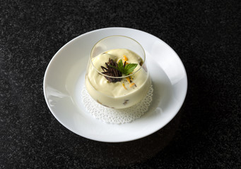 Dessert tiramisu with mint in a transparent glass