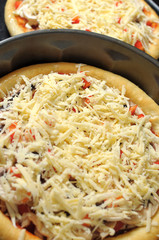 Homemade pizza, process of cooking. Layer of grated cheese