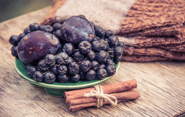 Ripe aronia and aromatic plum. Autumn concept. Garden harvest.