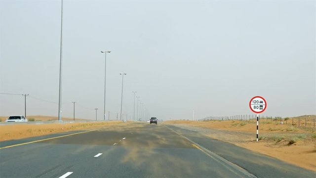 4x4 off road land vehicle taking tourists on desert dune bashing safari in Dubai, UAE