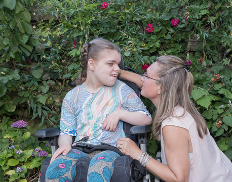 Disability A Disabled Child In A Wheelchair Relaxing In The Garden